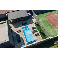 Rektangulär blå Glasfiberpool Aruba 700 med kakelkanter och vattenripplor