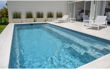 Leisurepools Harmony-pool – rektangulær form, klart blåt vand, hvide flisekanter