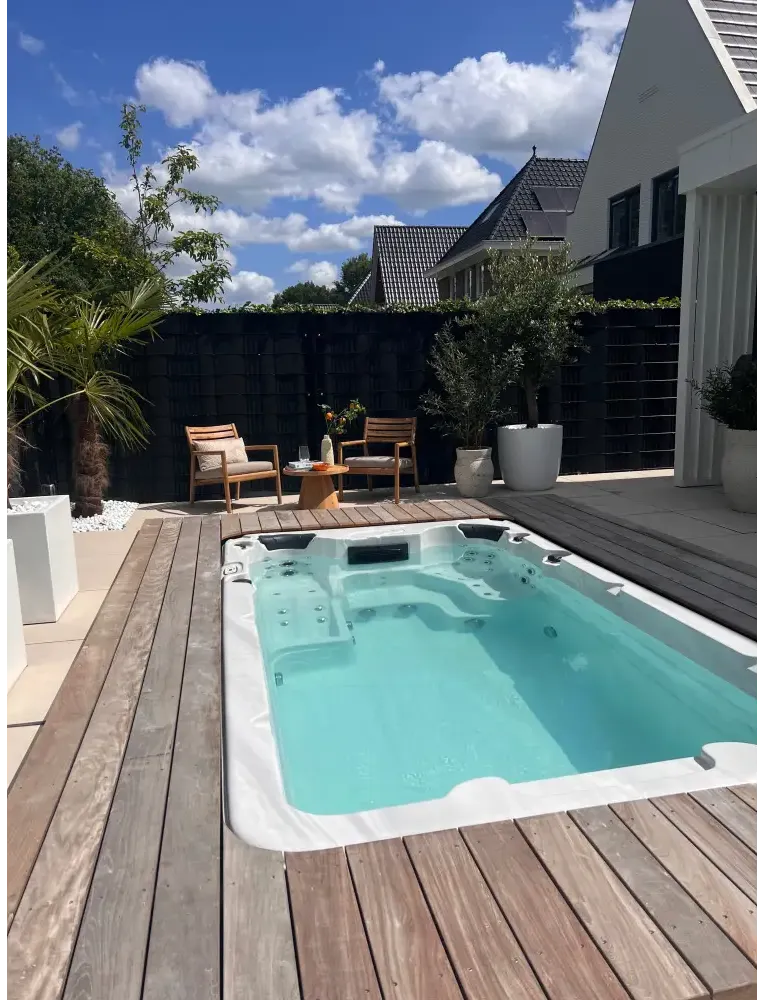 PassionSpa Aquatic 1-swimspa – Sport Collection, hvid overflade, rektangulær form, turkisblåt vand, indbyggede massagedyser, træterrasse