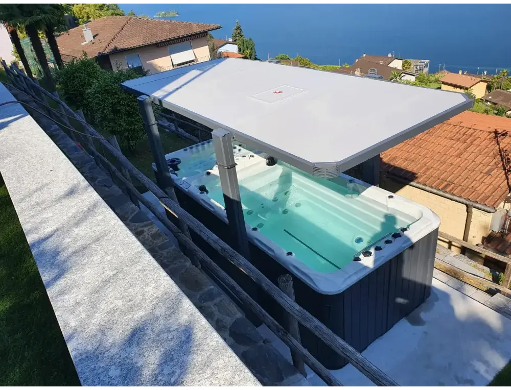 PassionSpa Spirit-swimspa – gråt design, hvidt låg, sorte massagedyser, stenterrasse, ved havet